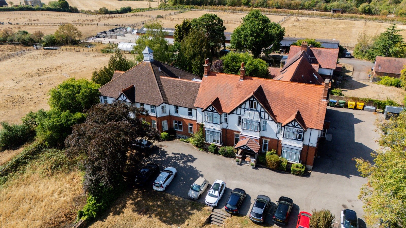Aerial drone view of the care home building and grounds surrounded by open fields